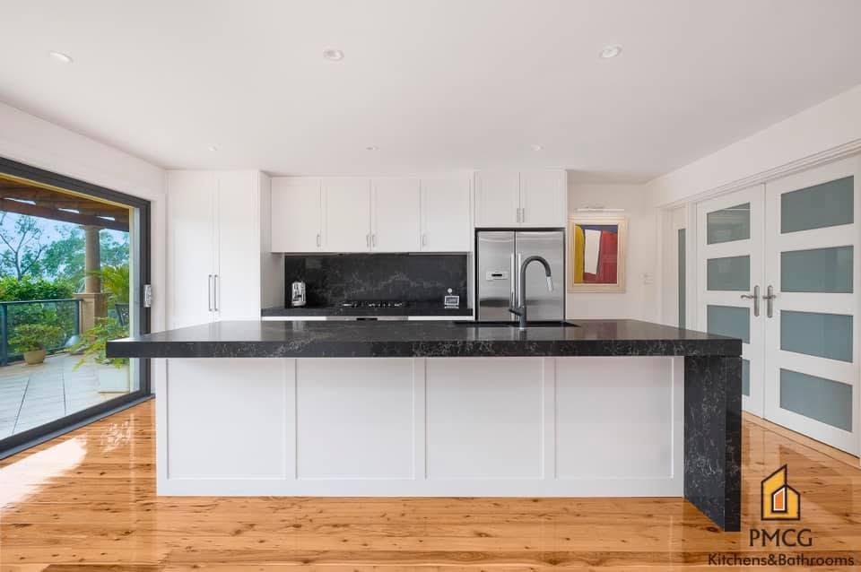 Modern kitchen renovation with white stone benchtop and pendant lighting — St Ives