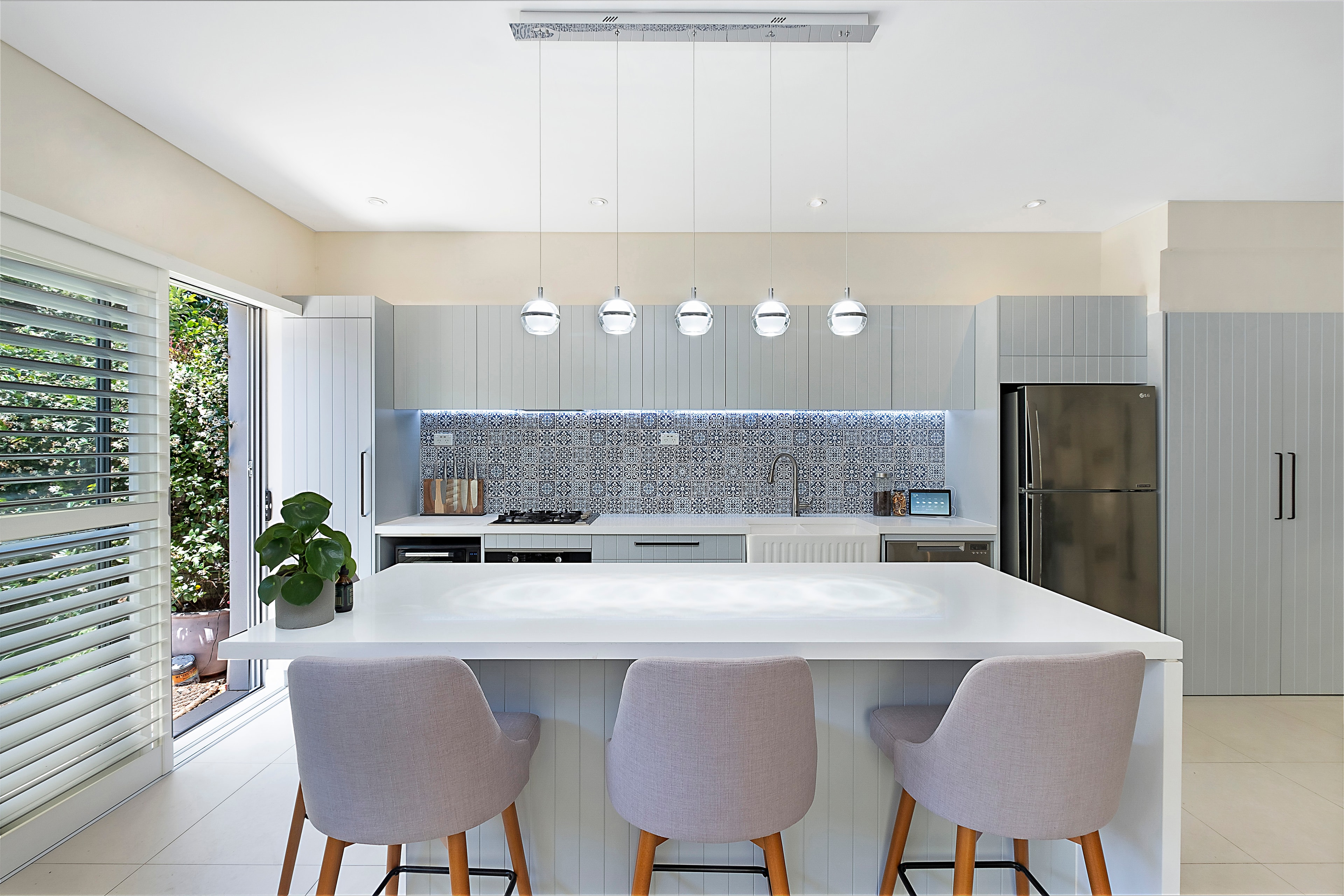 Modern kitchen renovation with island seating and pendant lights — Lane Cove